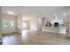 Spacious living room featuring wood-look tile flooring, neutral paint, and modern lighting at 11483 Poorwill Ave, Brooksville, FL 34614