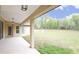 Covered patio with ample space for outdoor seating overlooking the expansive backyard at 11483 Poorwill Ave, Brooksville, FL 34614