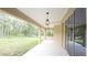 Covered back patio offers serene views of the surrounding nature and private backyard at 11483 Poorwill Ave, Brooksville, FL 34614