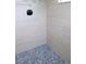 Shower with accent tile and stone floor at 11483 Poorwill Ave, Brooksville, FL 34614