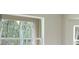 A refreshing view of the lush green trees seen through the window at 11483 Poorwill Ave, Brooksville, FL 34614