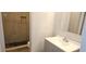 This bathroom features a tiled shower with a dark floor and a vanity with a white sink at 11511 113Th St # 4F, Seminole, FL 33778