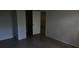 Bedroom showcasing neutral walls, tiled floors, and a view into another room through a doorway at 11511 113Th St # 4F, Seminole, FL 33778