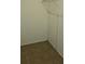 A basic closet with tiled floor, blank walls, and a closed door on the right at 11511 113Th St # 4F, Seminole, FL 33778