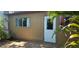 Exterior view showing a window and door surrounded by greenery, creating a private entrance at 11511 113Th St # 4F, Seminole, FL 33778
