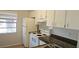 Well-lit kitchen featuring white cabinets, a stove, and a refrigerator at 11511 113Th St # 4F, Seminole, FL 33778