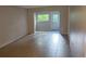 Living room showcasing tile flooring, neutral walls and outdoor views at 11511 113Th St # 4F, Seminole, FL 33778
