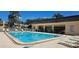 Community pool with lounge chairs and tables offers a relaxing and social gathering spot for residents at 11511 113Th St # 4F, Seminole, FL 33778