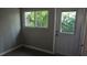 Room with neutral walls, tiled floors, a window with green views, and a white door to outside at 11511 113Th St # 4F, Seminole, FL 33778