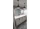 Bathroom featuring double sinks, a large mirror, and modern pendant lighting at 123 S Dolphin Dr, Oldsmar, FL 34677