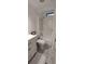 This bathroom features a tub shower with white wood-look flooring and white wainscoting at 123 S Dolphin Dr, Oldsmar, FL 34677