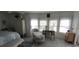 Bright bedroom with hardwood floors, cottage style furniture, and three large windows at 123 S Dolphin Dr, Oldsmar, FL 34677