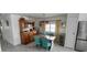 Bright dining room featuring vintage cabinet, stainless refrigerator, and seating for four at 123 S Dolphin Dr, Oldsmar, FL 34677