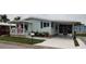 Charming single-story home with well-maintained lawn, carport, and covered porch at 123 S Dolphin Dr, Oldsmar, FL 34677