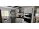 Modern kitchen with stainless appliances, white cabinets, and white subway tile backsplash at 123 S Dolphin Dr, Oldsmar, FL 34677