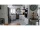 Bright kitchen with white cabinets, stainless steel appliances, dark countertops and white wood flooring at 123 S Dolphin Dr, Oldsmar, FL 34677