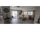Cozy living room featuring white wood floors, a comfortable white sofa, and ample natural light at 123 S Dolphin Dr, Oldsmar, FL 34677