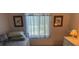 Charming bedroom with a twin bed and artwork, creating a comfortable and inviting space at 1258 Pine Ridge W Cir # F1, Tarpon Springs, FL 34688