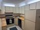 Functional kitchen space featuring white appliances and cabinets at 1258 Pine Ridge W Cir # F1, Tarpon Springs, FL 34688