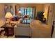 Relaxing living room with comfortable seating, a large window, and a TV at 1258 Pine Ridge W Cir # F1, Tarpon Springs, FL 34688