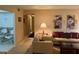 Comfortable living room with floral wall decor, seating, and natural light at 1258 Pine Ridge W Cir # F1, Tarpon Springs, FL 34688