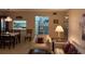 Open living area with dining table, living room seating, and a lamp at 1258 Pine Ridge W Cir # F1, Tarpon Springs, FL 34688