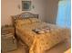 Warm bedroom with a patterned bedspread and wooden headboard at 1258 Pine Ridge W Cir # F1, Tarpon Springs, FL 34688