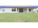 Spacious backyard with a covered patio and sliding glass doors to let the light shine in at 13098 Convent Garden Rd, Brooksville, FL 34614