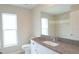 Bathroom featuring a granite countertop vanity, a large mirror, and a tiled shower at 13098 Convent Garden Rd, Brooksville, FL 34614