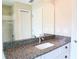 Bathroom featuring a granite countertop vanity, a large mirror, and a tiled shower with sliding glass doors at 13098 Convent Garden Rd, Brooksville, FL 34614