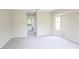 Bright and spacious bedroom featuring neutral carpet and paint, with an adjoining bathroom at 13098 Convent Garden Rd, Brooksville, FL 34614