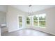 Bright dining area with large windows, modern lighting, and a door to the patio at 13098 Convent Garden Rd, Brooksville, FL 34614
