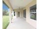 Spacious covered porch with view of backyard and sliding glass door entry to home at 13098 Convent Garden Rd, Brooksville, FL 34614