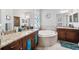 Luxurious bathroom featuring a soaking tub, double vanities with granite countertops, and tile flooring at 13523 Meadow Golf Ave, Hudson, FL 34669