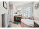 Elegant bathroom with a soaking tub, granite countertops, and tiled floors for a spa-like experience at 13523 Meadow Golf Ave, Hudson, FL 34669