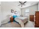 Comfortable bedroom with neutral walls, a window, and wood furniture creating a cozy retreat at 13523 Meadow Golf Ave, Hudson, FL 34669
