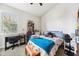Bright bedroom with a large window, desk, and bed with a plush blue blanket at 13523 Meadow Golf Ave, Hudson, FL 34669