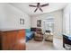 Cozy bedroom featuring a comfortable leather recliner, desk, and a large window at 13523 Meadow Golf Ave, Hudson, FL 34669