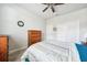 Bedroom with carpeted floors, wood furniture, and closet doors, providing a calm space at 13523 Meadow Golf Ave, Hudson, FL 34669