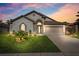 Charming one-story home with a well-manicured lawn, lovely landscaping, and a two-car garage at 13523 Meadow Golf Ave, Hudson, FL 34669