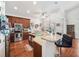 Well-equipped kitchen features stainless steel appliances, breakfast bar, and hardwood floors at 13523 Meadow Golf Ave, Hudson, FL 34669