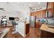 Open kitchen with stainless steel appliances, bar seating, and hardwood floors at 13523 Meadow Golf Ave, Hudson, FL 34669