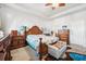 Comfortable main bedroom with coastal decor, a ceiling fan, and plush carpeting for relaxation at 13523 Meadow Golf Ave, Hudson, FL 34669