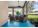 Inviting screened-in patio with comfortable seating and outdoor charm at 13523 Meadow Golf Ave, Hudson, FL 34669