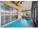 Spacious screened-in patio with comfortable seating that leads to the backyard at 13523 Meadow Golf Ave, Hudson, FL 34669