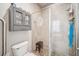 Tiled shower with glass door, wall-mounted storage, and a seating area, offering a clean design at 13523 Meadow Golf Ave, Hudson, FL 34669