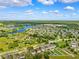 Expansive aerial view of the community, featuring multiple lakes, homes, and green spaces at 13722 Lakemont Dr, Hudson, FL 34669