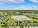 Scenic aerial view of the neighborhood showcasing a tranquil lake surrounded by lush greenery at 13722 Lakemont Dr, Hudson, FL 34669