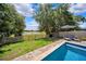 Backyard featuring a pool, a fence, and a view of the lake at 13722 Lakemont Dr, Hudson, FL 34669