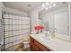 Bathroom featuring a vanity with a sink, striped shower curtain, and tile flooring at 13722 Lakemont Dr, Hudson, FL 34669